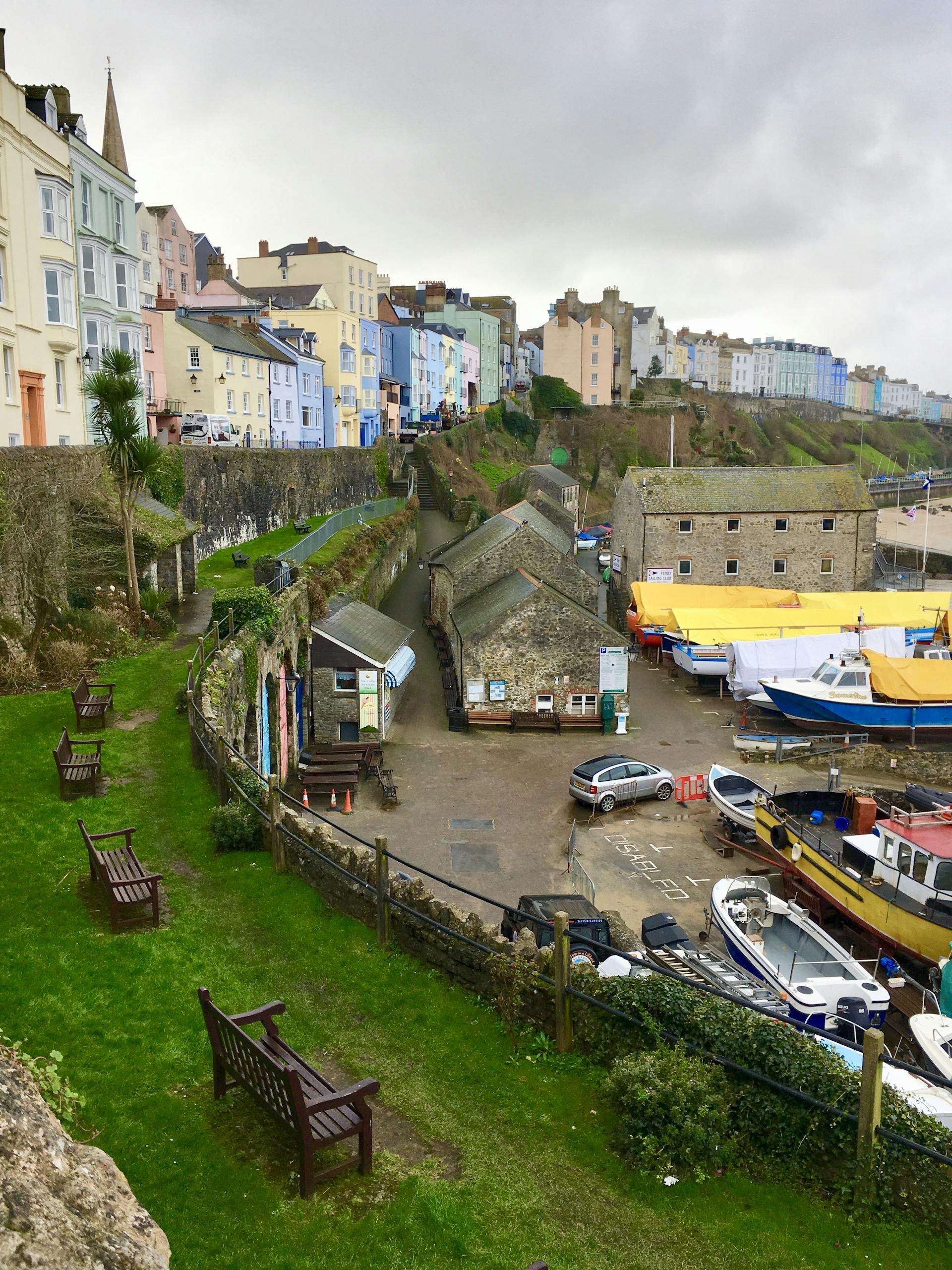 Charming coastal town with colorful houses and a bustling harbor scene.